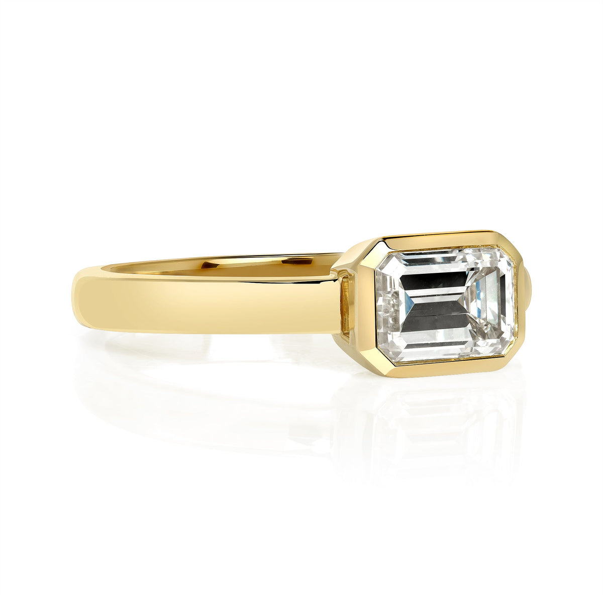 SINGLE STONE LEAH RING featuring 1.04ct K/VS2 GIA certified emerald cut diamond bezel set in a handcrafted 18K yellow gold mounting,