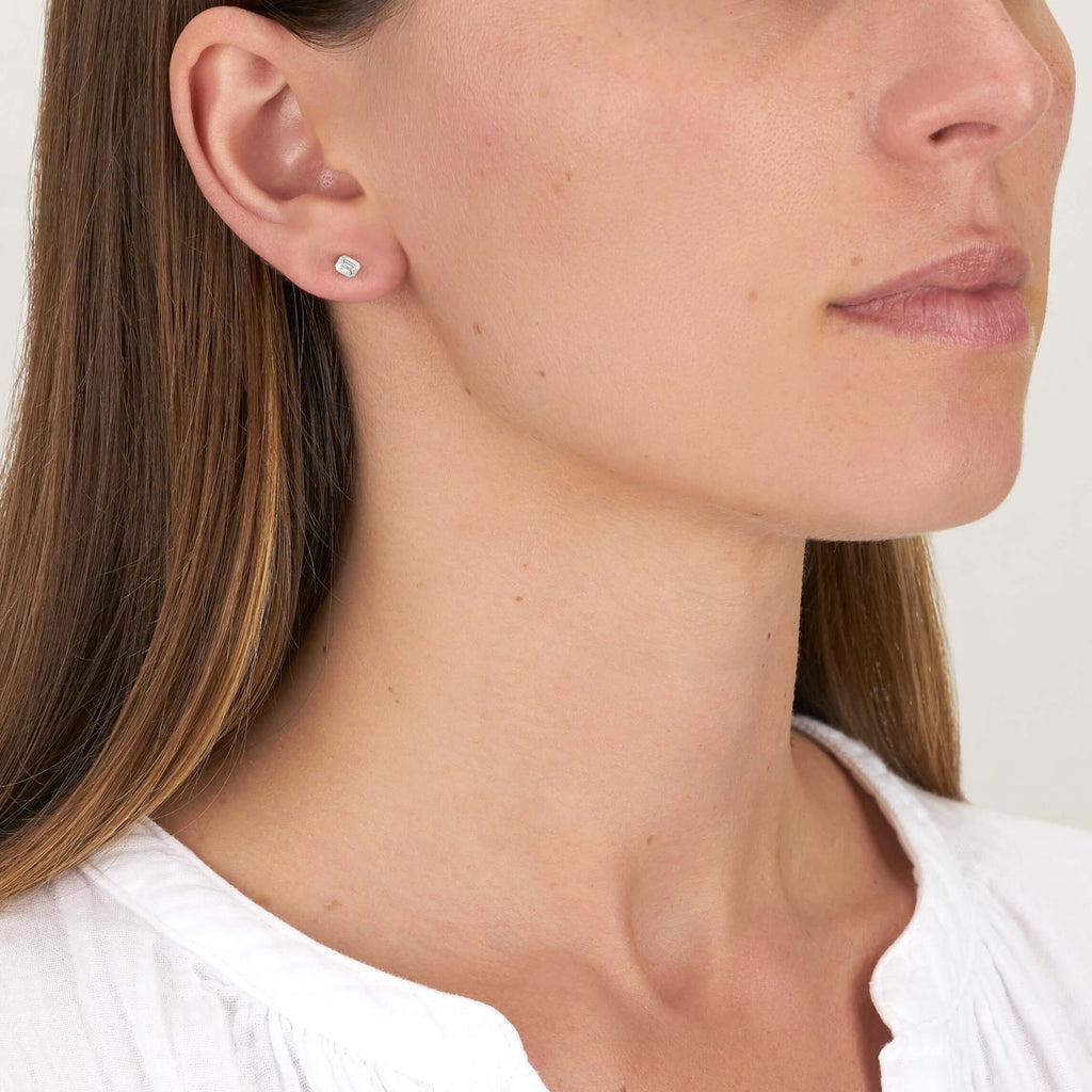 SINGLE STONE SIERRA STUDS | Earrings featuring Approximately 0.18ctw G-I/VS emerald cut diamonds bezel set in handcrafted stud earrings.