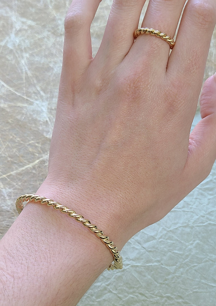 SINGLE STONE LARA BANGLE featuring Handcrafted twisted 18K yellow gold bangle bracelet.