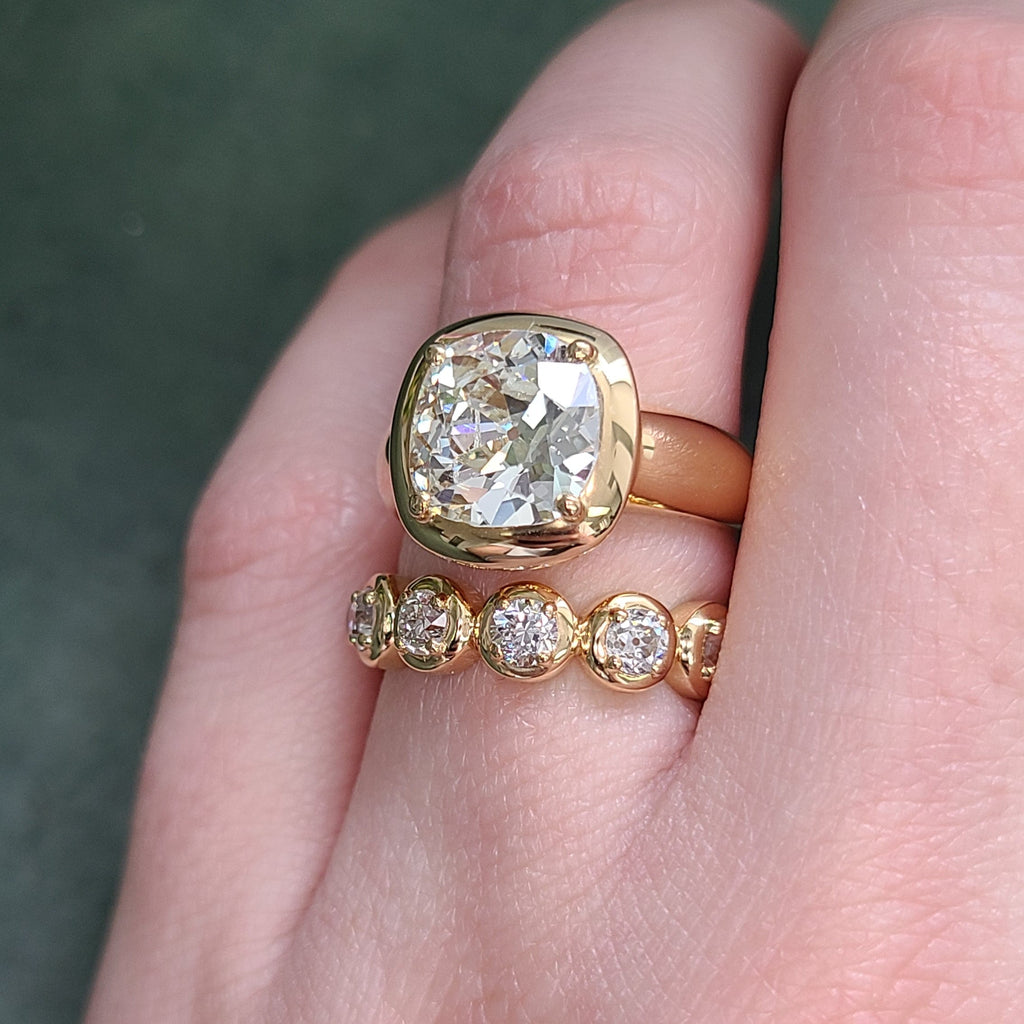SINGLE STONE RANDI BAND | Approximately 1.90ctw G-H/VS-SI old European cut diamonds prong set in a handcrafted 18K yellow gold eternity band. Approximate band width 5mm.