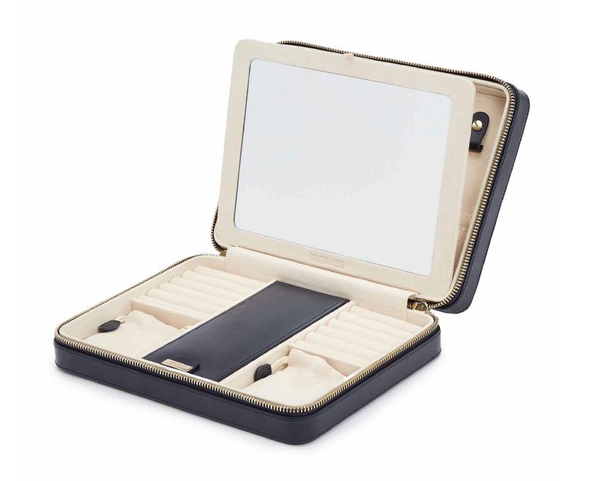MARIA LARGE ZIP CASE, Material: Leather 
Storage: 10 ring rolls, 2 open compartments, 1 lidded compartment, 2 drawstring pouches,  6 necklace snap-on hooks with pocket, 1 ring bar, one earring bar. 
LusterLoc™: Allows the fabric lining the inside of your jewellery cases to absorb the hostile gases known to cause tarnishing. Under typical storage conditions, it can prevent tarnishing for up to 35 years 

, Gifts, WOLF DESIGNS, INC