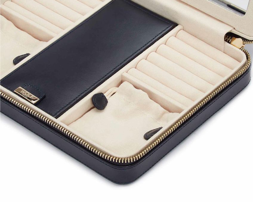 MARIA LARGE ZIP CASE, Material: Leather 
Storage: 10 ring rolls, 2 open compartments, 1 lidded compartment, 2 drawstring pouches,  6 necklace snap-on hooks with pocket, 1 ring bar, one earring bar. 
LusterLoc™: Allows the fabric lining the inside of your jewellery cases to absorb the hostile gases known to cause tarnishing. Under typical storage conditions, it can prevent tarnishing for up to 35 years 

, Gifts, WOLF DESIGNS, INC