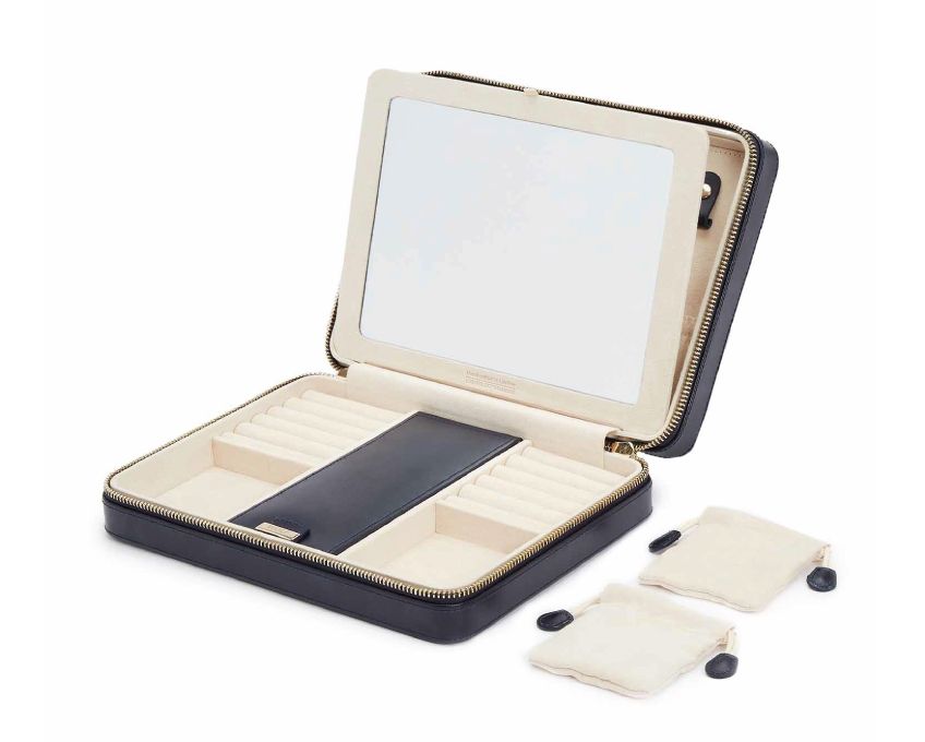MARIA LARGE ZIP CASE, Material: Leather 
Storage: 10 ring rolls, 2 open compartments, 1 lidded compartment, 2 drawstring pouches,  6 necklace snap-on hooks with pocket, 1 ring bar, one earring bar. 
LusterLoc™: Allows the fabric lining the inside of your jewellery cases to absorb the hostile gases known to cause tarnishing. Under typical storage conditions, it can prevent tarnishing for up to 35 years 

, Gifts, WOLF DESIGNS, INC