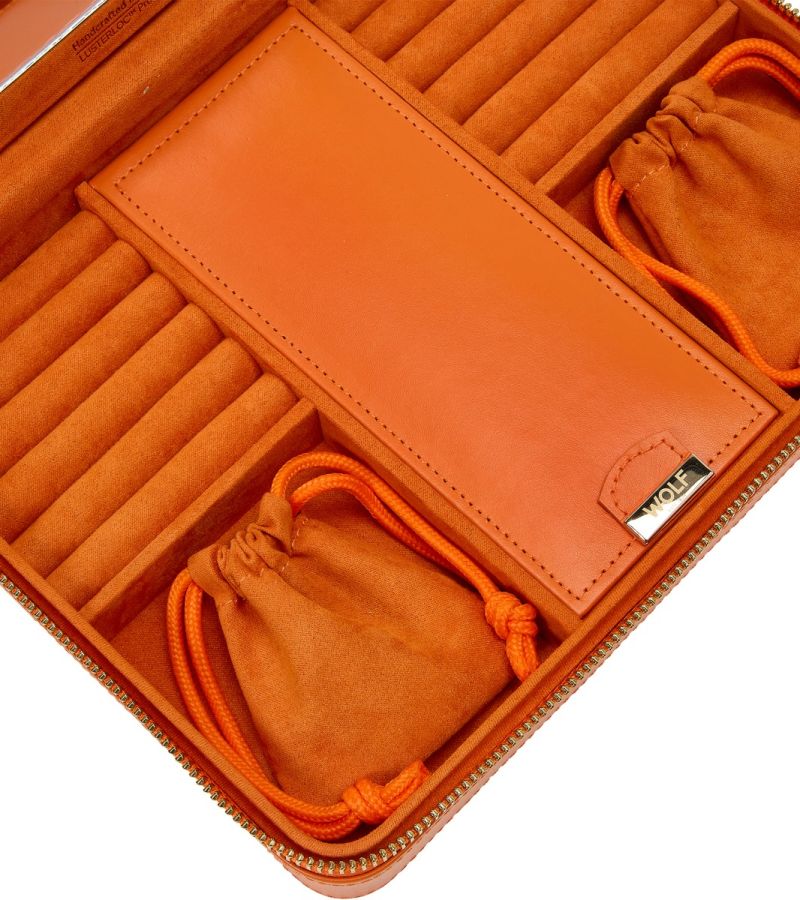 MARIA LARGE ZIP CASE, Material: Leather 
Storage: 10 ring rolls, 2 open compartments, 1 lidded compartment, 2 drawstring pouches,  6 necklace snap-on hooks with pocket, 1 ring bar, one earring bar. 
LusterLoc™: Allows the fabric lining the inside of your jewellery cases to absorb the hostile gases known to cause tarnishing. Under typical storage conditions, it can prevent tarnishing for up to 35 years 

, Gifts, WOLF DESIGNS, INC