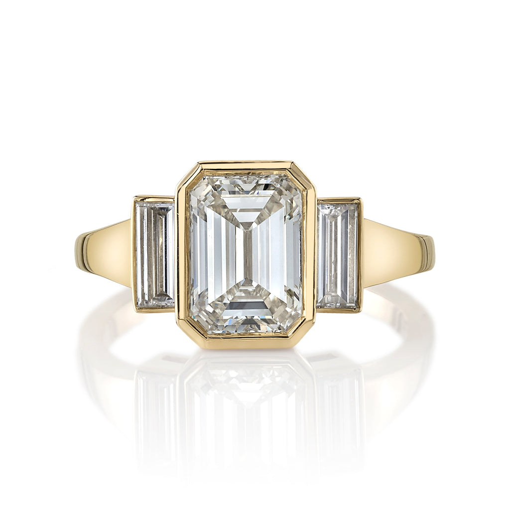 SINGLE STONE AMELIA RING featuring 2.00ct N/VVS2 GIA certified emerald cut diamond with 0.35ctw baguette cut accent diamonds bezel set in a handcrafted 18K yellow gold mounting.