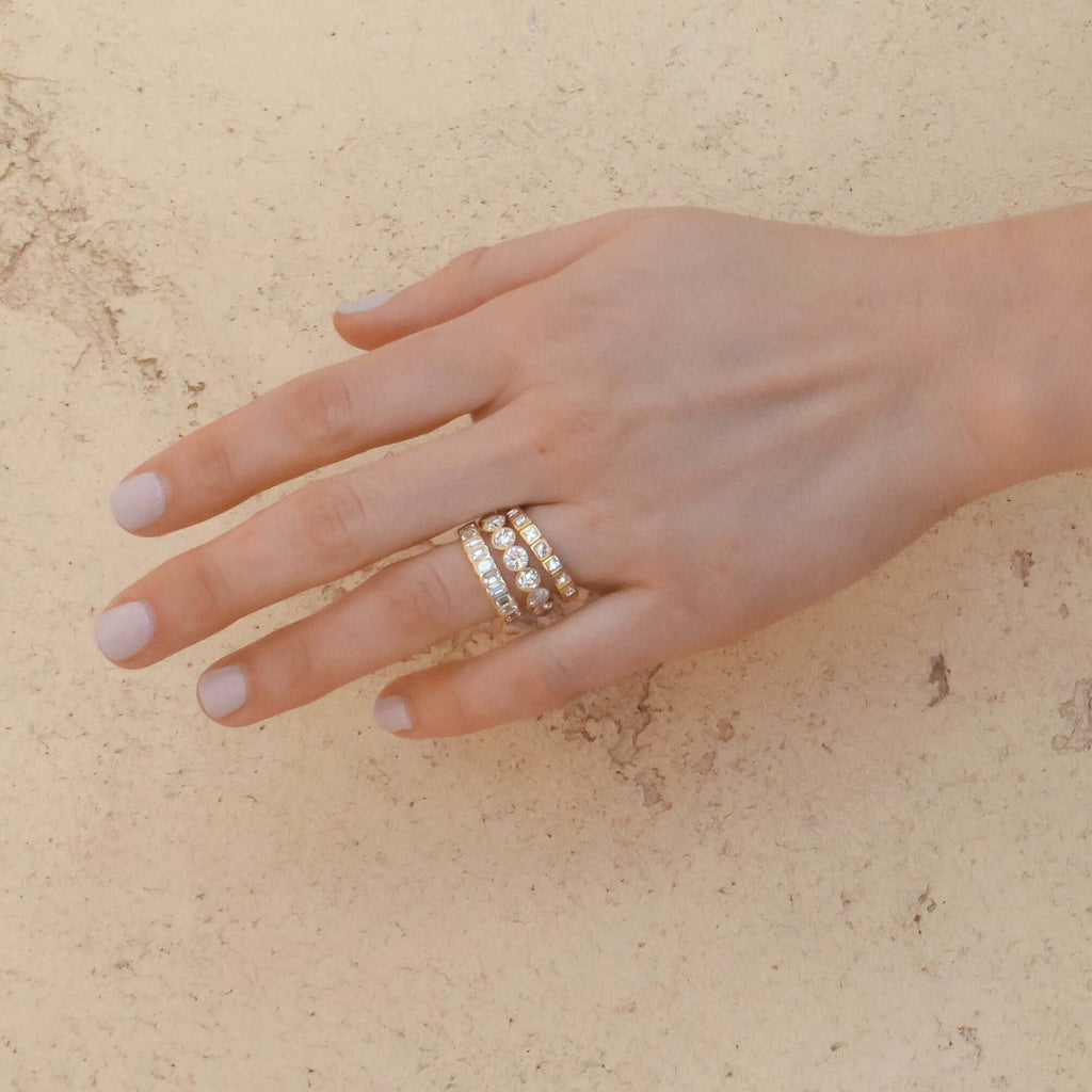 SINGLE STONE ATHENA BAND | Approximately 2.50ctw H-I/VS emerald cut diamonds bezel set in a handcrafted eternity band. Approximate band width 4mm. Please inquire for additional customization.