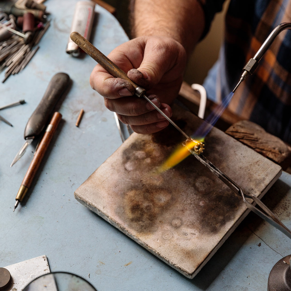 A Single Stone jeweler crafting a ring from the collection.