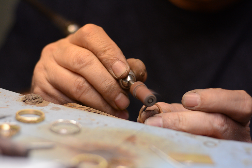 A Single Stone jeweler crafting a ring from the collection.