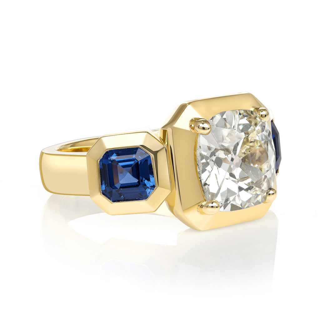 SINGLE STONE GLORIA RING featuring 2.86ct O-P/I2 GIA certified antique cushion cut diamond with 1.50ctw Asscher cut blue sapphires set in a handcrafted 18K yellow gold mounting.