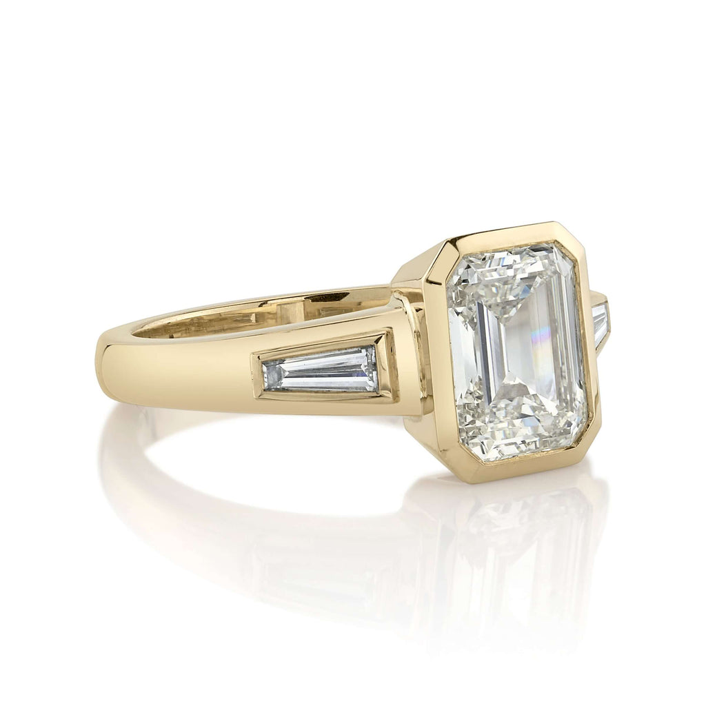 SINGLE STONE LAURIE RING featuring 2.00ct N/VS2 GIA certified emerald cut diamond with 0.24ctw baguette cut accent diamonds bezel set in a handcrafted 18K yellow gold mounting.