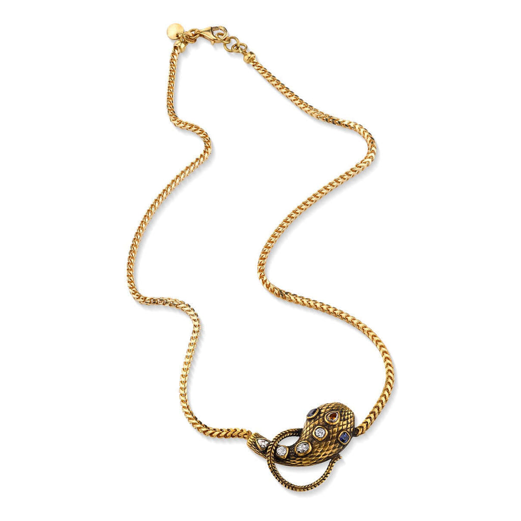 SINGLE STONE ALEXANDRIA SERPENT NECKLACE featuring 0.86ctw antique old mine, antique cushion, and pear cut diamonds featuring 0.44ctw cushion cut blue sapphire accent stones set on a handcrafted, oxidized 18K yellow gold snake pendant. Includes18K yellow