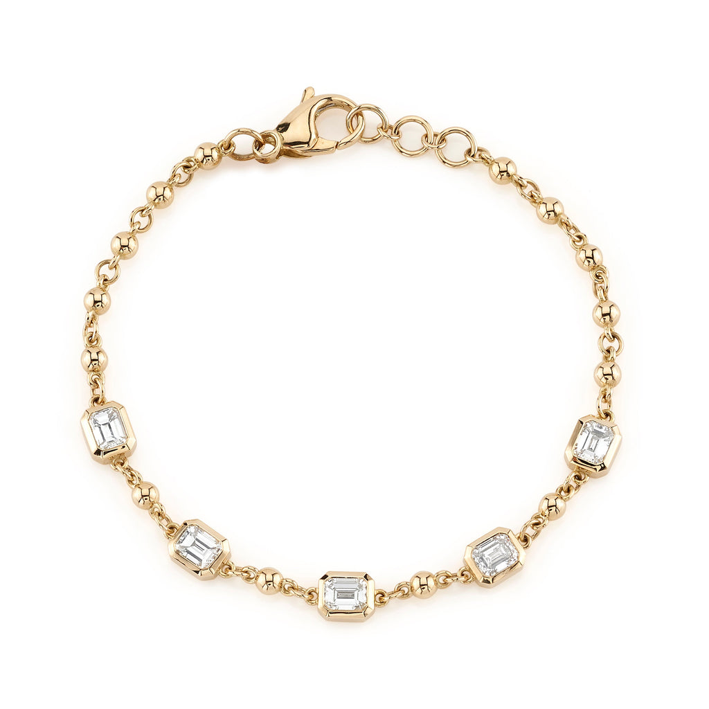 SINGLE STONE FIVE STONE SERALINA BRACELET featuring Approximately 2.50ctw J-K/VS bezel set emerald cut diamonds on a handcrafted 18K yellow gold rosary bracelet.