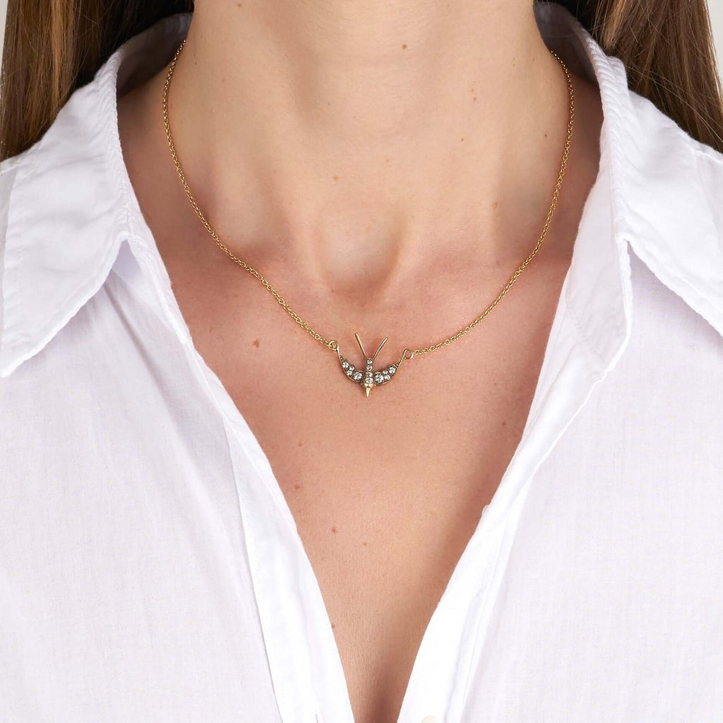 SINGLE STONE SMALL SWALLOW PENDANT NECKLACE featuring 0.32ctw G-H/VS old European cut diamonds set in a handcrafted 18K yellow and champagne gold Swallow pendant. Necklace measures 16".