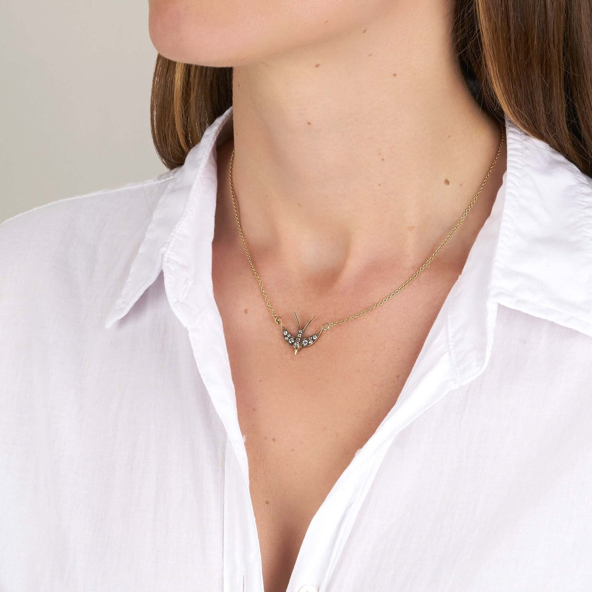 SINGLE STONE SMALL SWALLOW PENDANT NECKLACE featuring 0.32ctw G-H/VS old European cut diamonds set in a handcrafted 18K yellow and champagne gold Swallow pendant. Necklace measures 16".