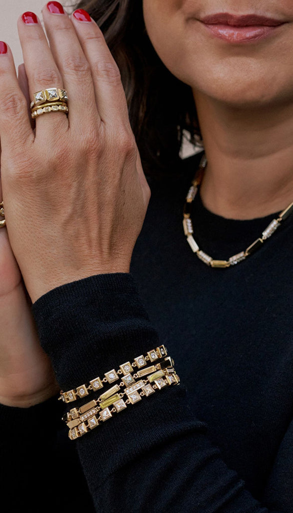 Store owner Corina Madilian wearing a selection of Single Stone jewelry.