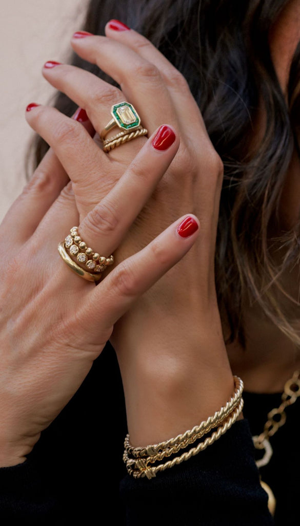 Store owner Corina Madilian wearing a selection of Single Stone rings.