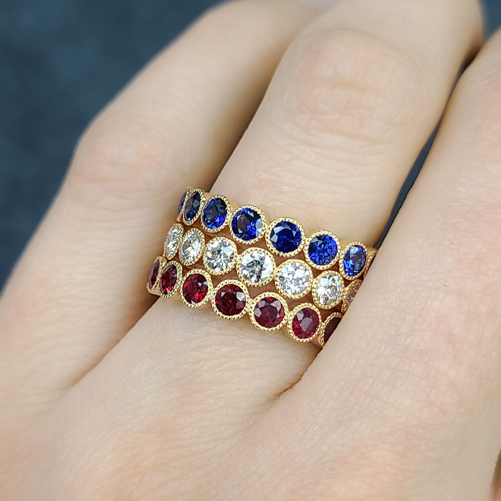 SINGLE STONE MEDIUM GABBY WITH GEMSTONES BAND | Approximately 2.30ctw round cut gemstones bezel set in a handcrafted eternity band. Approximate band with 3.6mm. Please inquire for additional customization.