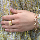 SINGLE STONE SIENNA BAND | Polished and domed 18K yellow gold cigar band measuring approximately 13mm across at its widest point. Please inquire for additional customization.