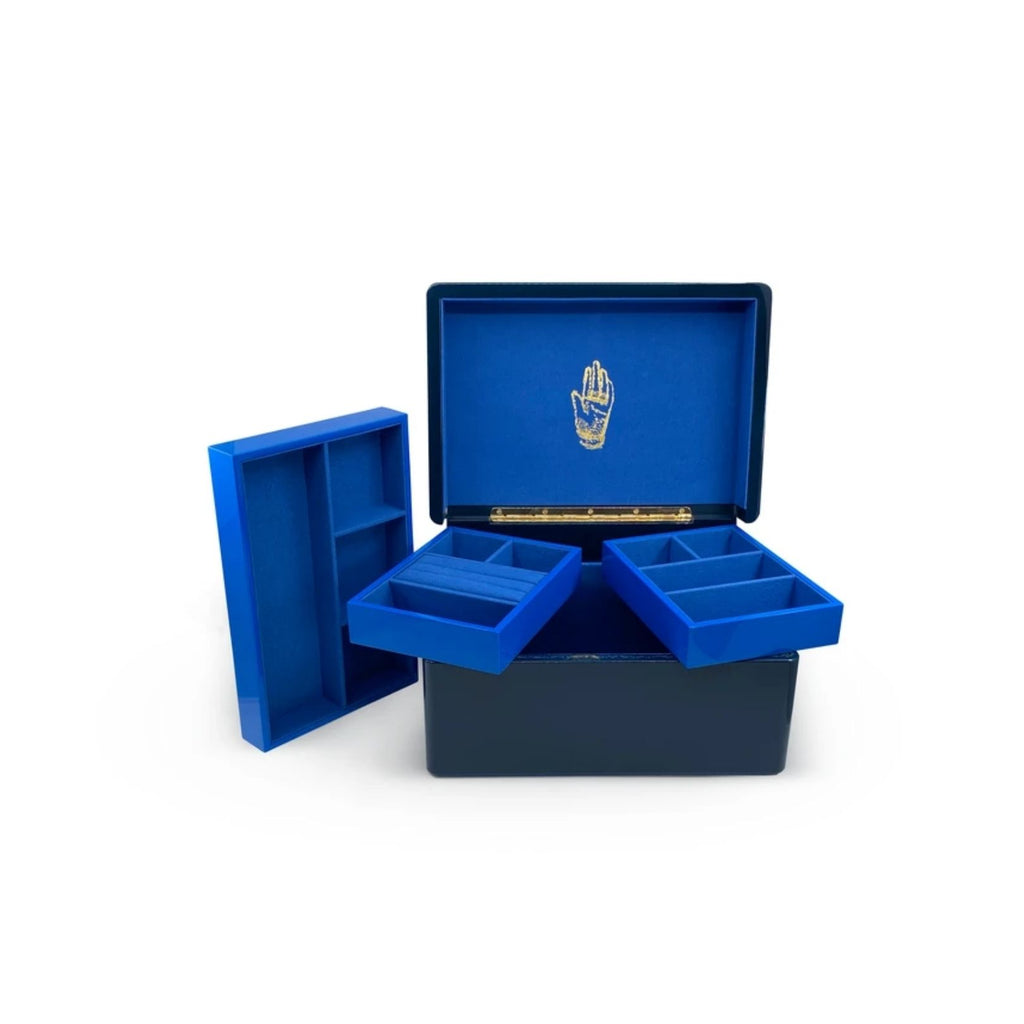 MIDNIGHT BLUE TRUNK, Color: Navy with Klein blue interior 3 levels of storage Wood with high lacquer finish Features delicate gold effect inlay Brass plated hardware Faux suede interior 11.8" x 8.3" x 6.3" Due to the nature of lacquer, there may be some v