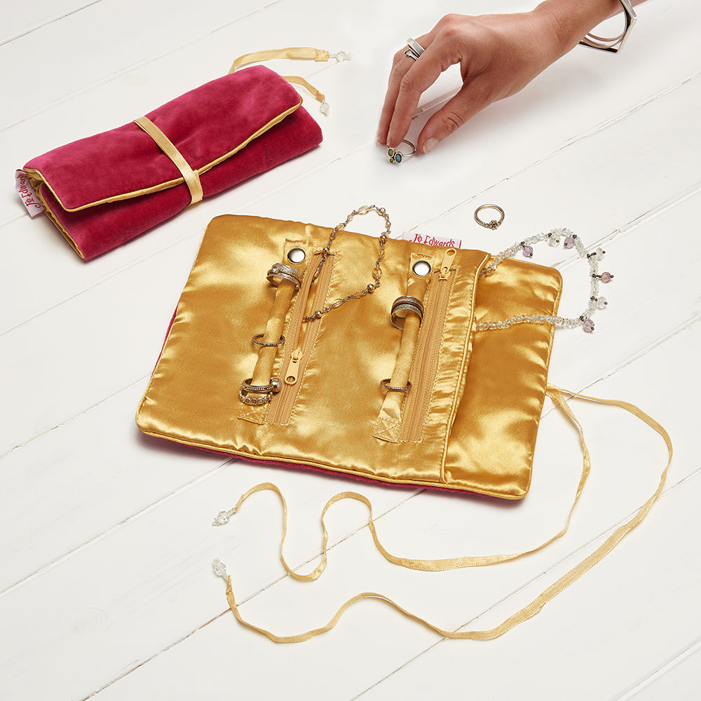 VELVET JEWELRY ROLL - ROSE, Rose colored velvet 
Golden satin linking and tie 
3 pockets; 1 main pocket, 2 zip pockets, and 2 ring holders which unclip, JEWELRY CASES, Jo Edwards London