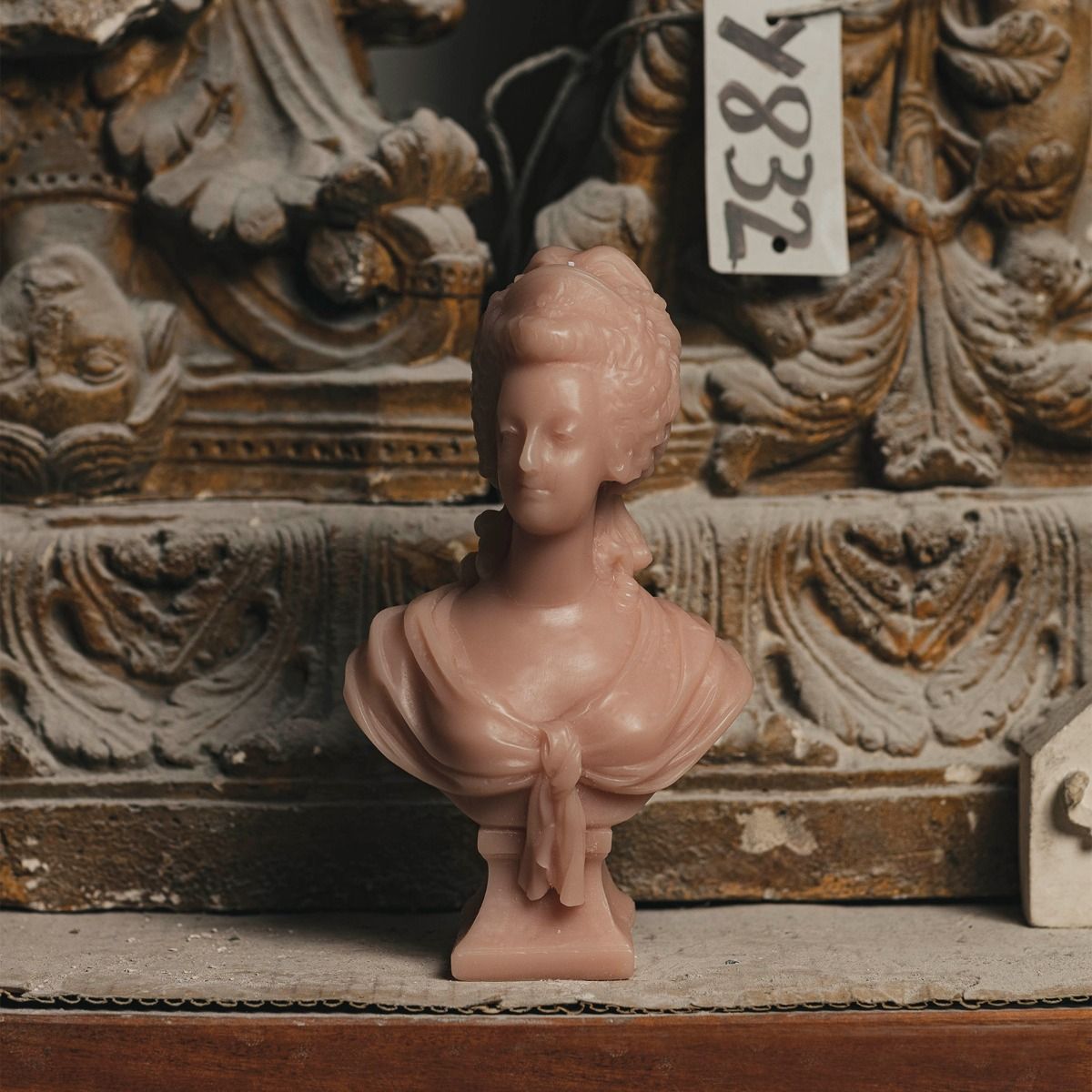 MARIE ANTOINETTE, This object is an idealized portrait of the queen instead of the evocation of a sovereign at the height of her power. The head is slightly turned to the right; the shoulders are covered with a swath of fabric for a natural effect; she is wearing a crown decorated with a fleur-delis and a row of pearls. As one of the most famous and controversial women in French History, Marie-Antoinette was the object of many artistic representations. 
Dimensions: 22 cm 
, Candle, Trudon