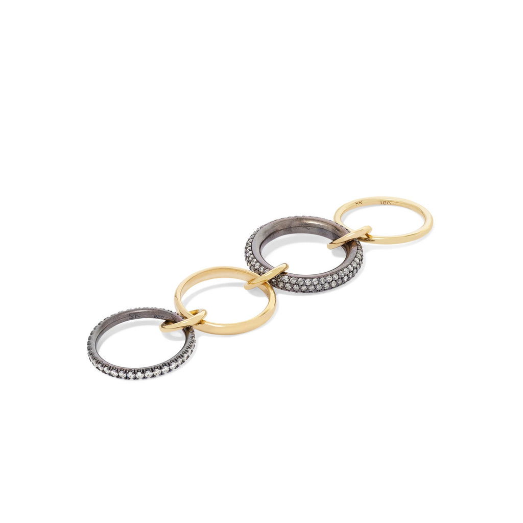 VEGA, Four linked rings in 18k yellow gold and black rhodium plated silver bands 
18k yellow gold connectors
 
1.90ct TW grey and white diamond pavé
 
Size 7 
Made in Los Angeles 
Final sale  
, Ring, Spinelli Kilcollin